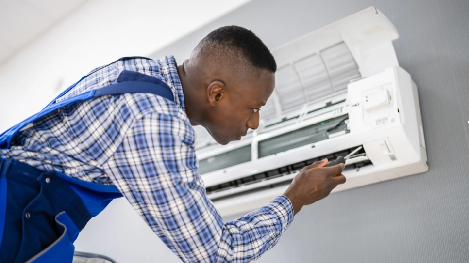 Skilled technician examines and repairs an air conditioning unit to ensure efficient cooling performance and system functionality.