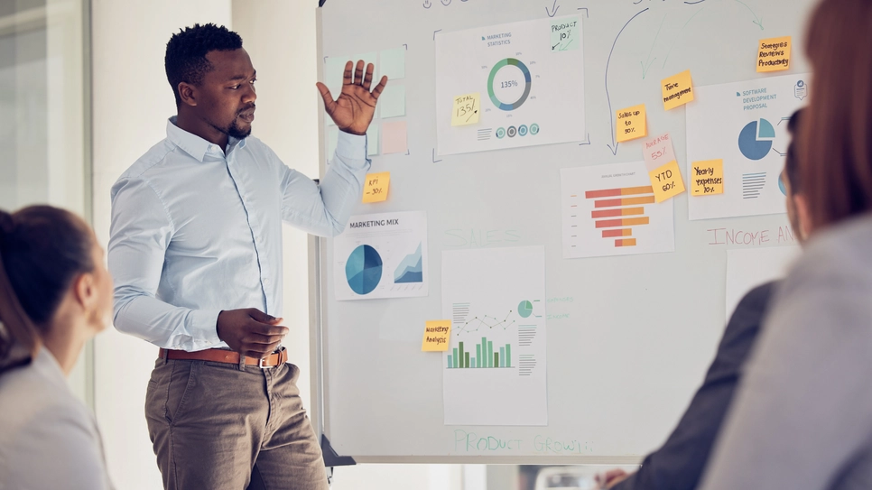 Accountant forecasting financial trends of a company in front of a board.