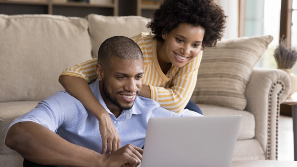 African homeowners looking at a computer.