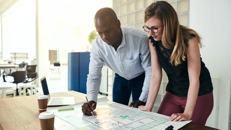 Black architect consulting with a female client.