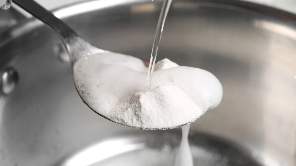 A spoon full of baking soda mixed with water.