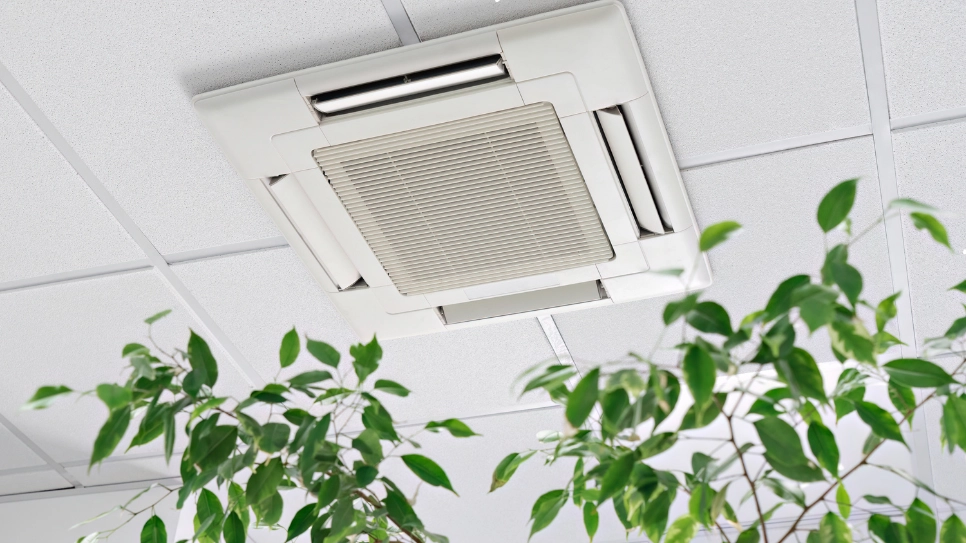 Ceiling-mounted central air conditioning unit in a modern interior, designed for efficient temperature control.