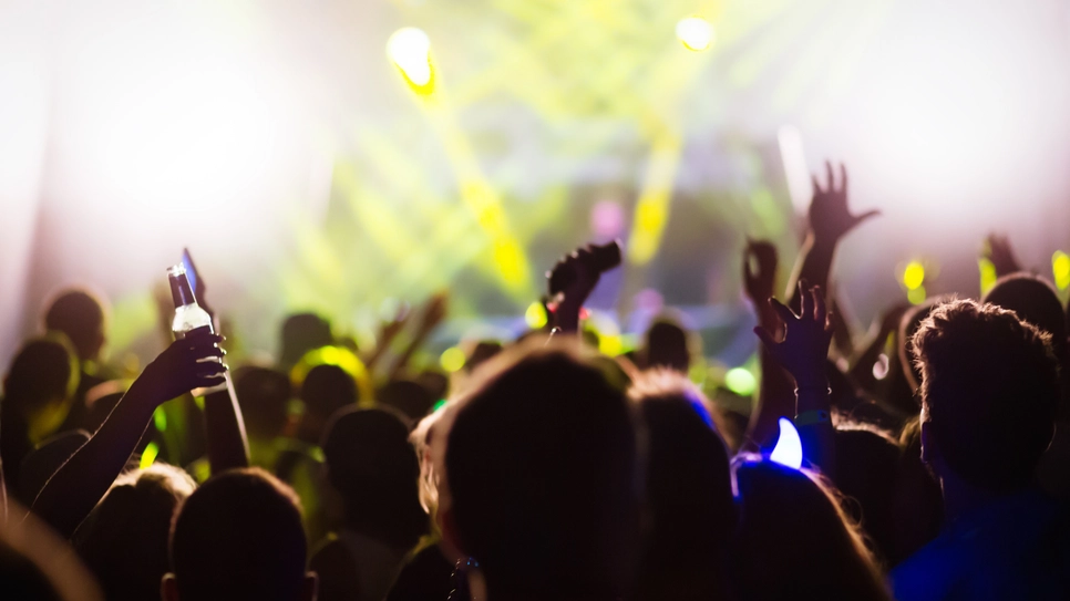 people's hands facing the stage at the music concerts