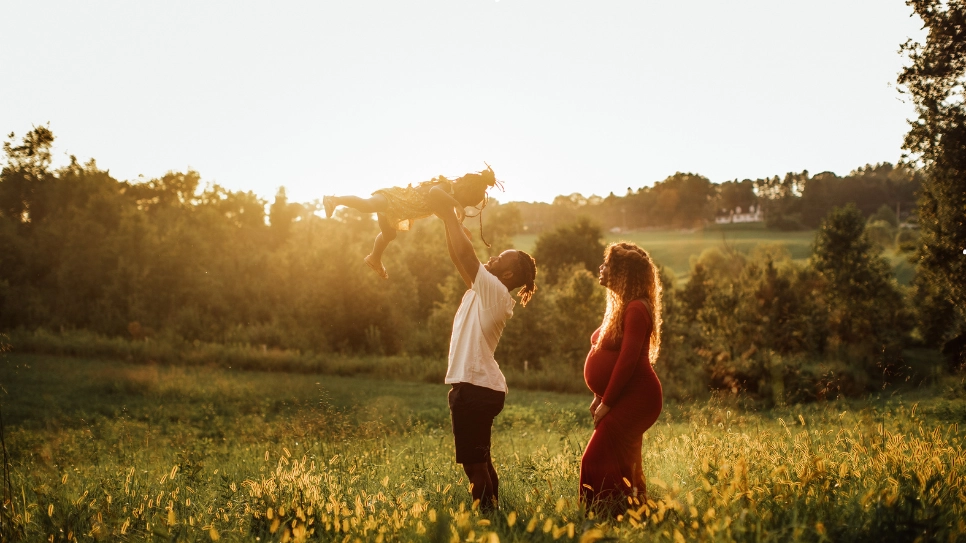 A family photoshoot in a natural setting during sunset, capturing warmth and connection against a scenic backdrop.