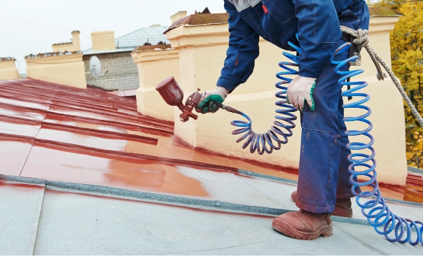 painter paints a metal roof