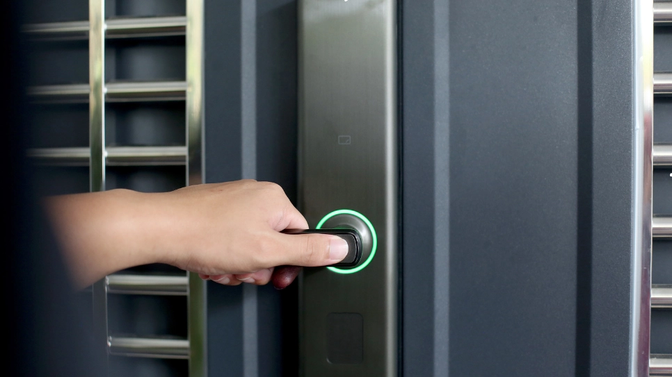 Hand using a biometric smart lock system, showcasing secure and convenient access control technology for modern homes.