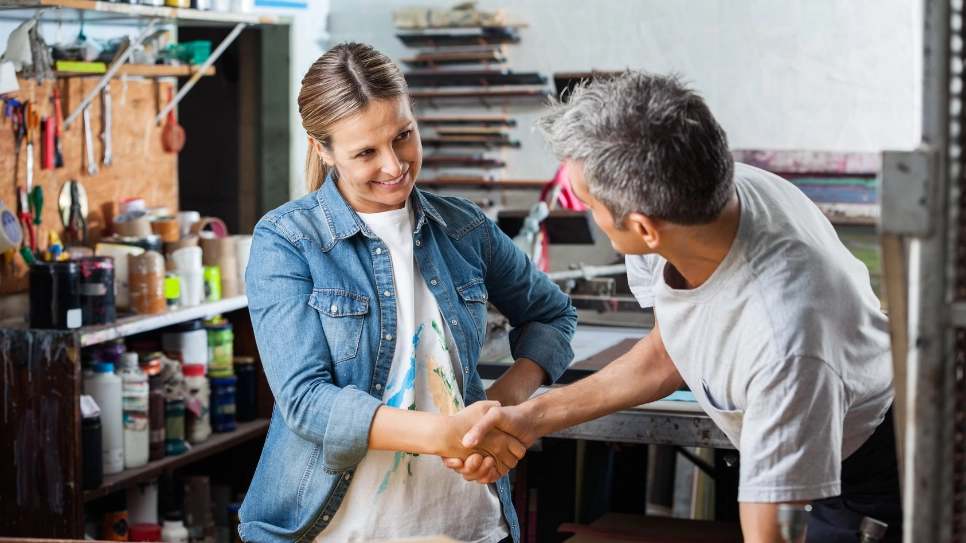 A customer and a pro shake hands.