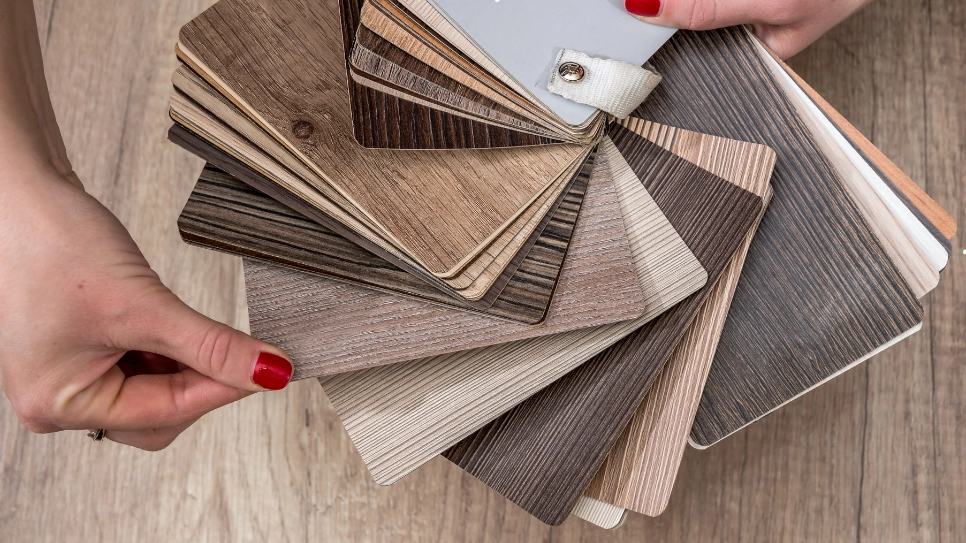 A selection of vinyl plank flooring samples in various wood tones, ideal for versatile and durable flooring solutions.