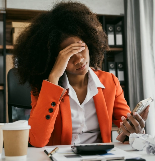 A woman dealing with workplace stress and multitasking, highlighting the challenges of maintaining a healthy work-life balance.